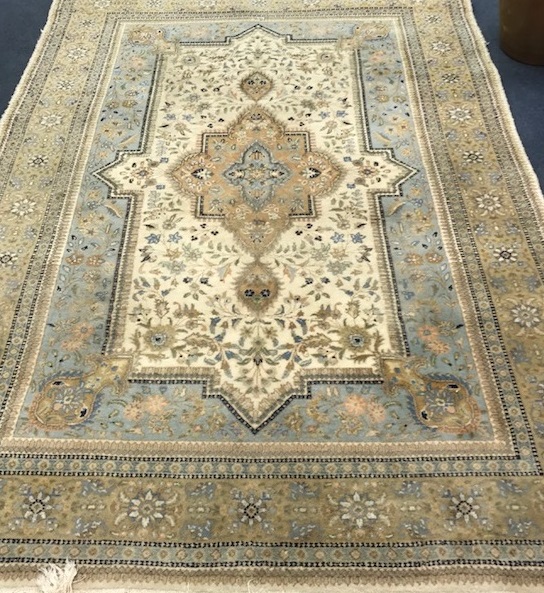 A Persian cream, grey and pale blue carpet 280 x 185cm